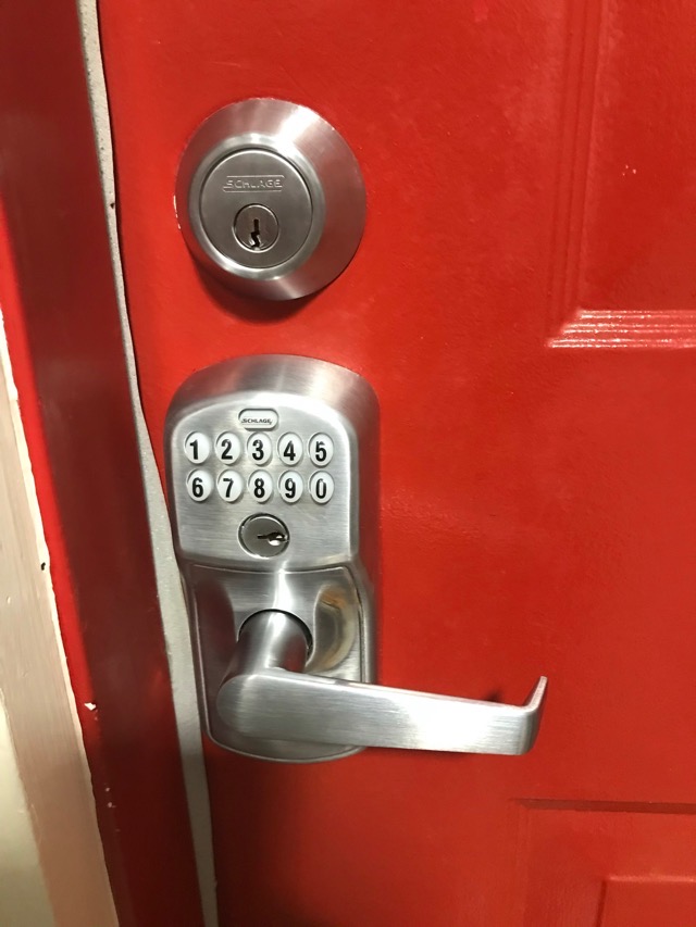 Residential Schlage silver digital keypad lock with lever handle and physical buttons with upper separate key entry